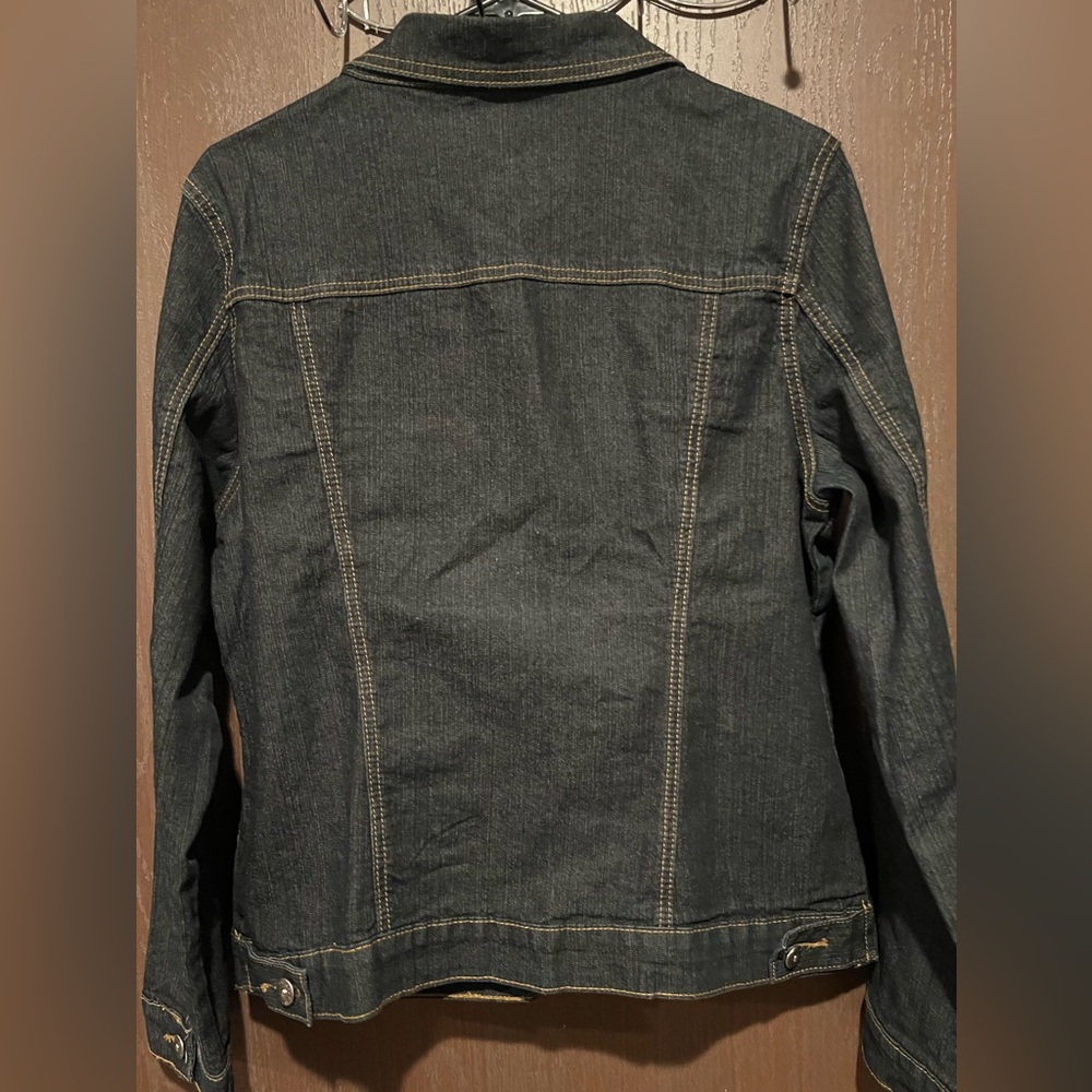 Dark denim jean jacket with floral design.